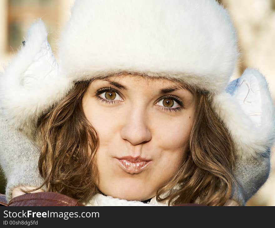 Portrait of grimacing girl in fur hat. Portrait of grimacing girl in fur hat