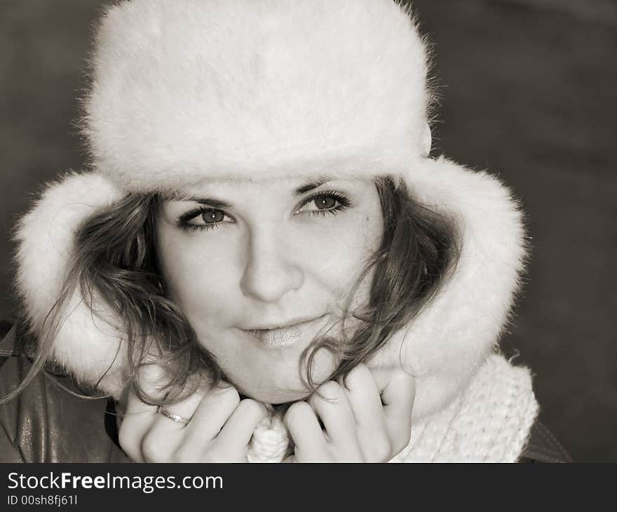 Portrait of smiling girl in fur hat, sepia. Portrait of smiling girl in fur hat, sepia