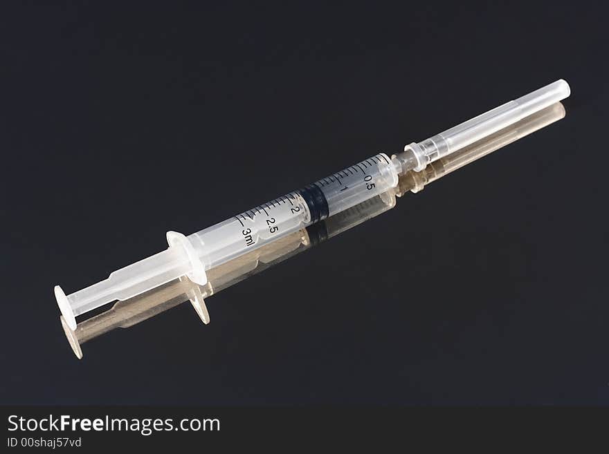 Syringe with shadow isolated on dark  background