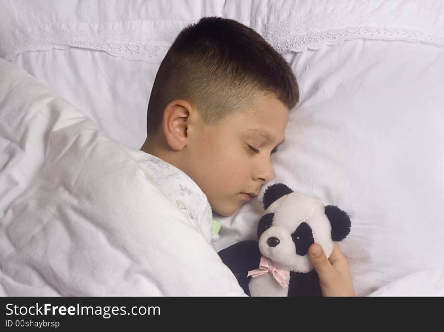 Boy asleep with  bear