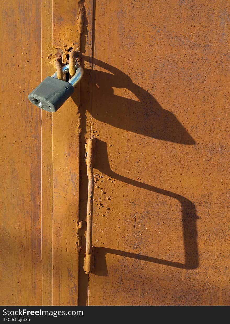 Lock on rusty door with shawdows