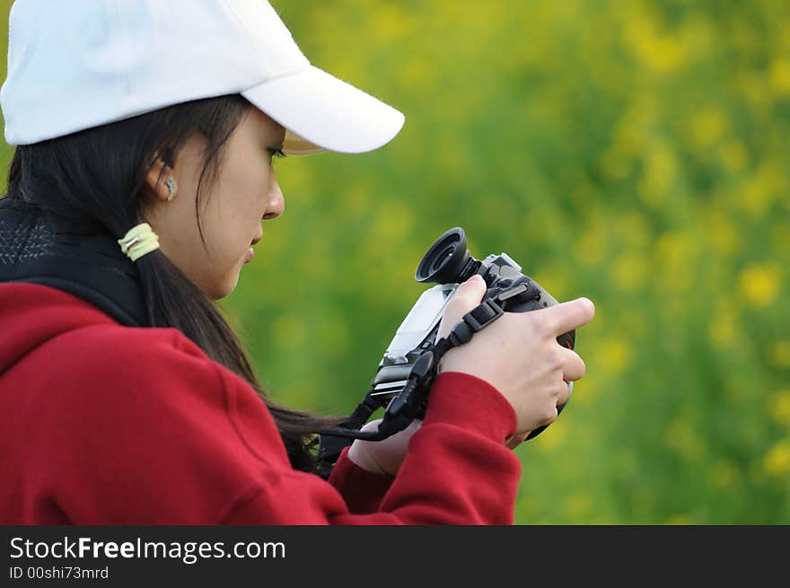 A woman photographer focusing on her subject. A woman photographer focusing on her subject