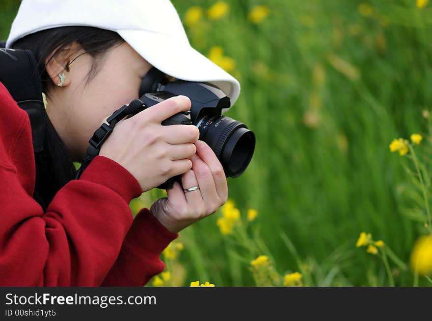 A woman photographer focusing on her subject. A woman photographer focusing on her subject