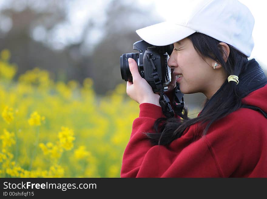 A woman photographer focusing on her subject. A woman photographer focusing on her subject