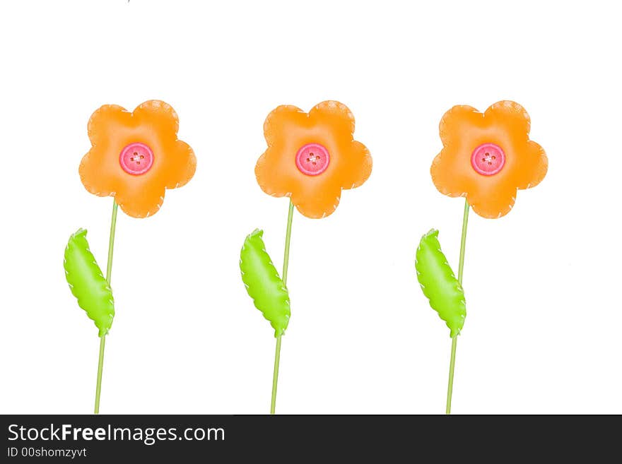 Three orange toy flowers  isolated on white