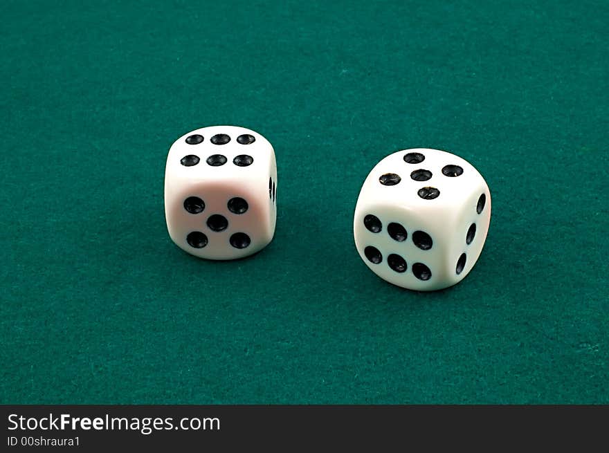 Dice sitting on green carpet