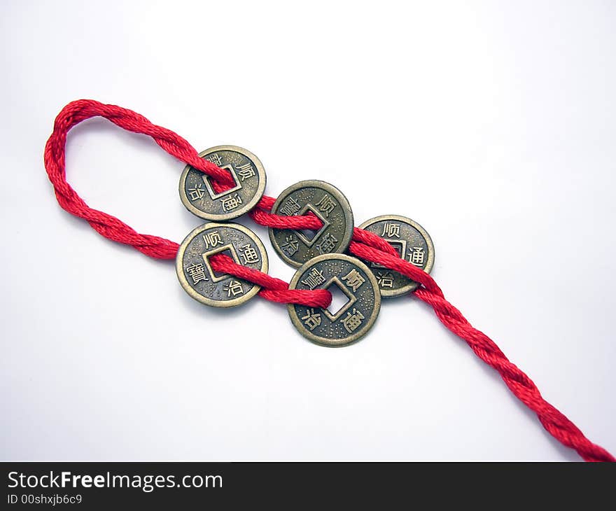 Five chinese Qing dynasty ancient coins chained with a red cord. Five chinese Qing dynasty ancient coins chained with a red cord