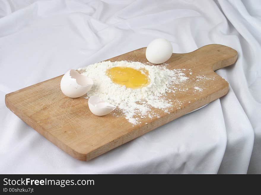 Eggs And A Flour On A Board