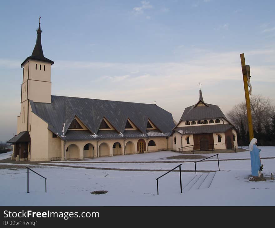 White beauty church. On the right small wooden cross