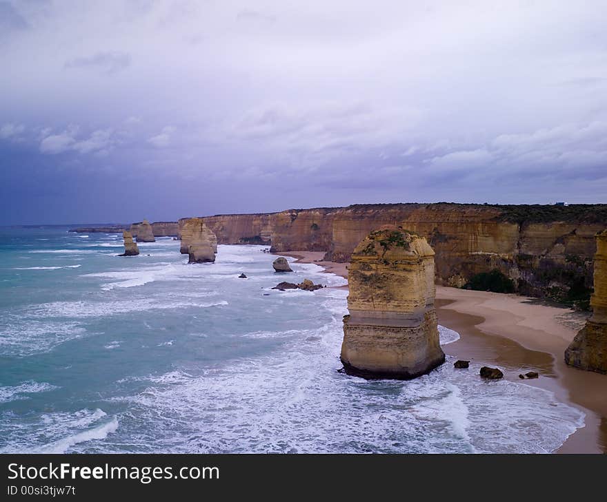 Eroded cliffs - stacks in ocean waves, Victoria, Australia. Eroded cliffs - stacks in ocean waves, Victoria, Australia