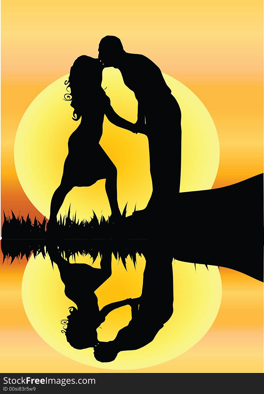 Silhouette of young romantic couple kissing by a river