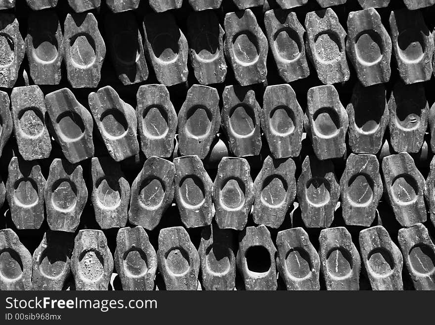 A stack of scaffold posts used to build a construction platform looking end on