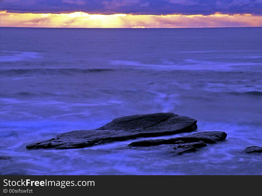 Large rocks in the shallows on the California coastline. Large rocks in the shallows on the California coastline