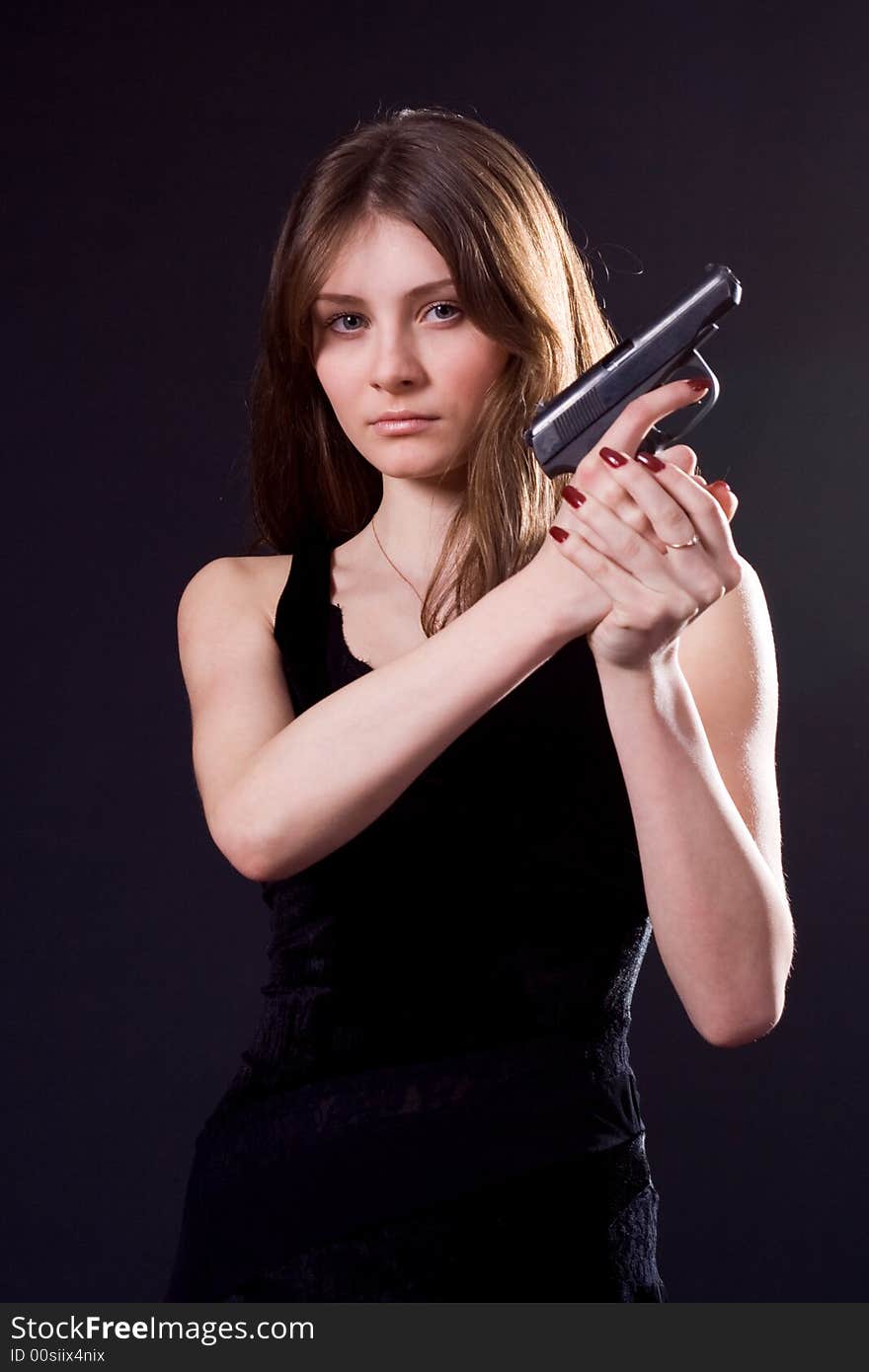 Lady in black handing pistol. Lady in black handing pistol