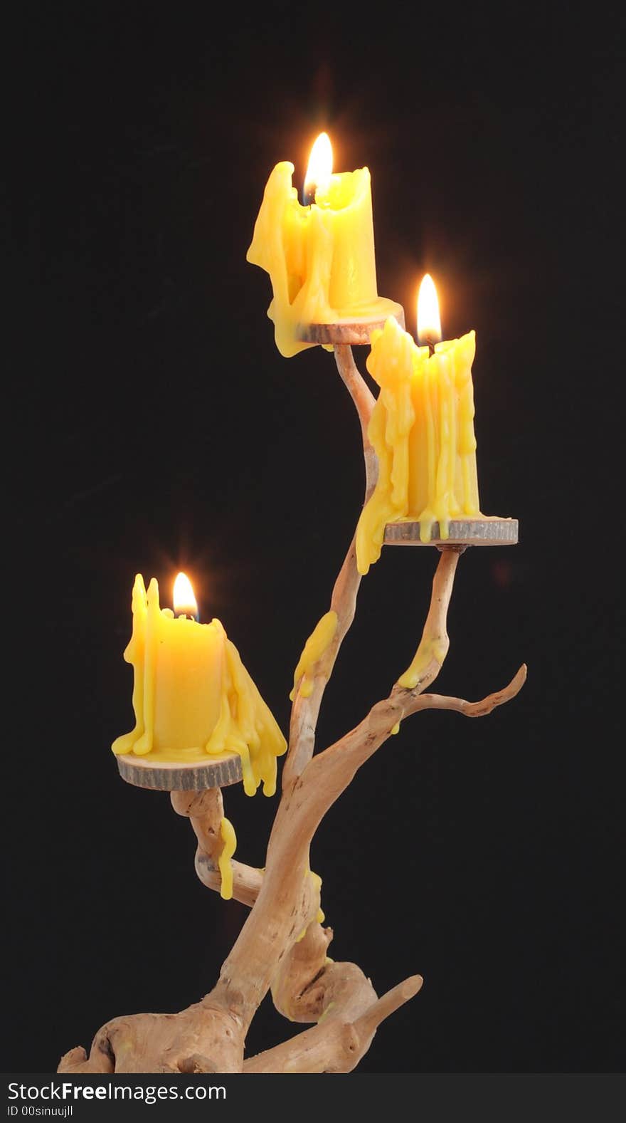 Three candles on a wooden candlestick