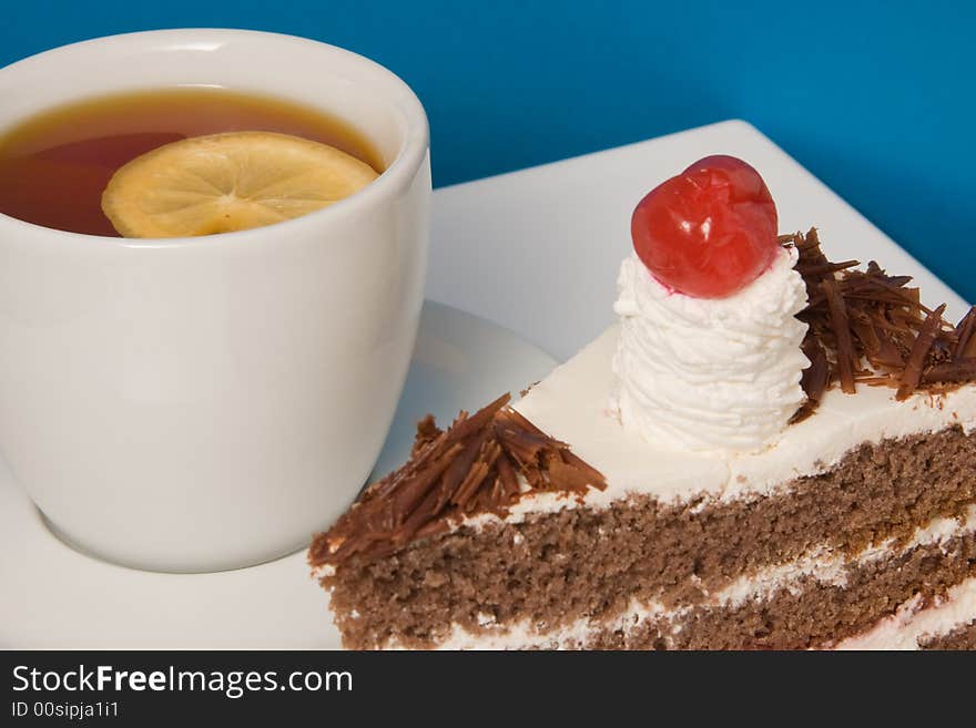 Cup of tea with lemon and cake