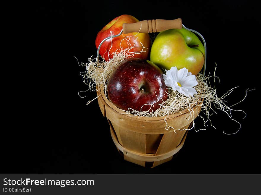 Apples in a wooden basket on black. Apples in a wooden basket on black.