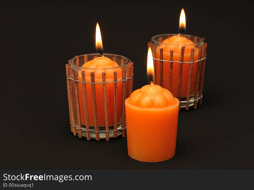 Fiery orange candles against black background