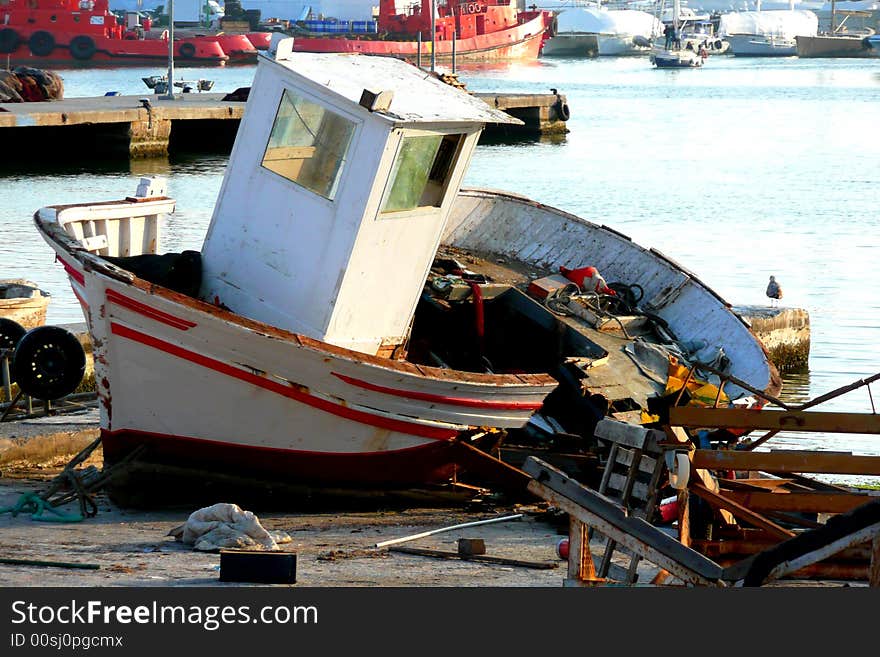 Wreck of a wooden boat in a boatyard . Wreck of a wooden boat in a boatyard