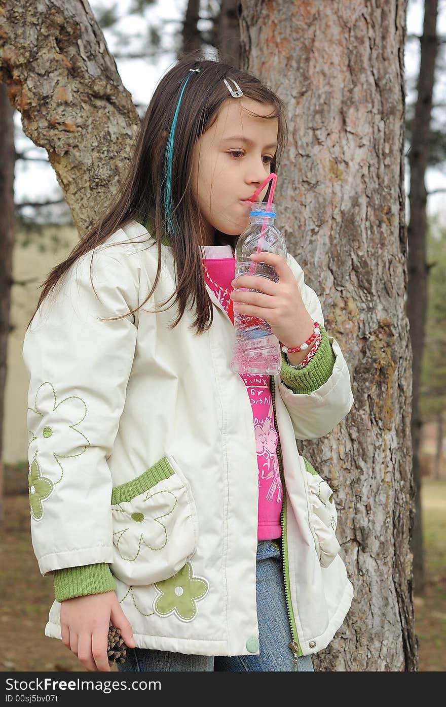 Little girl drinking mineral water. Little girl drinking mineral water