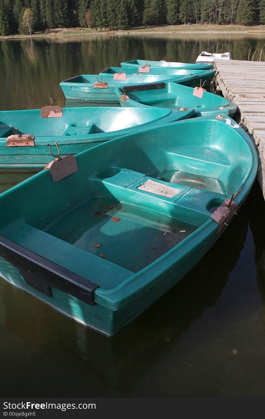 Six boats on the lake with reflection