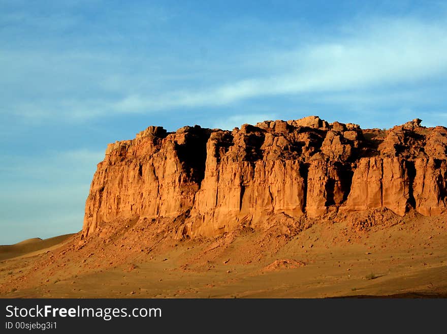 At gansu province in china, a grand golden rocky wall on the way to Dunhuang. At gansu province in china, a grand golden rocky wall on the way to Dunhuang.