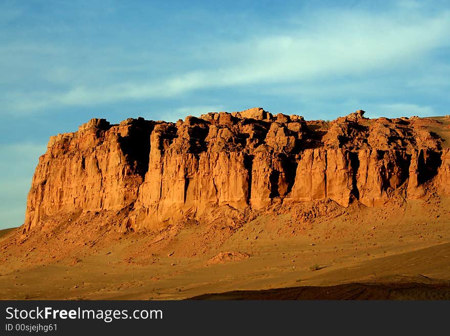 At gansu province in china, a grand golden rocky wall on the way to Dunhuang. At gansu province in china, a grand golden rocky wall on the way to Dunhuang.