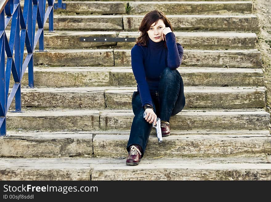 Woman with gun in steps.