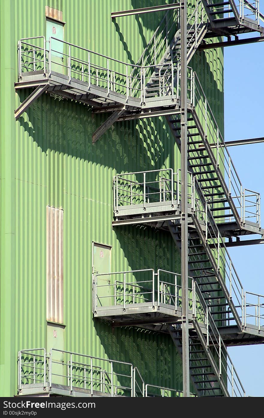 Green industrial building with stairs outside. Green industrial building with stairs outside