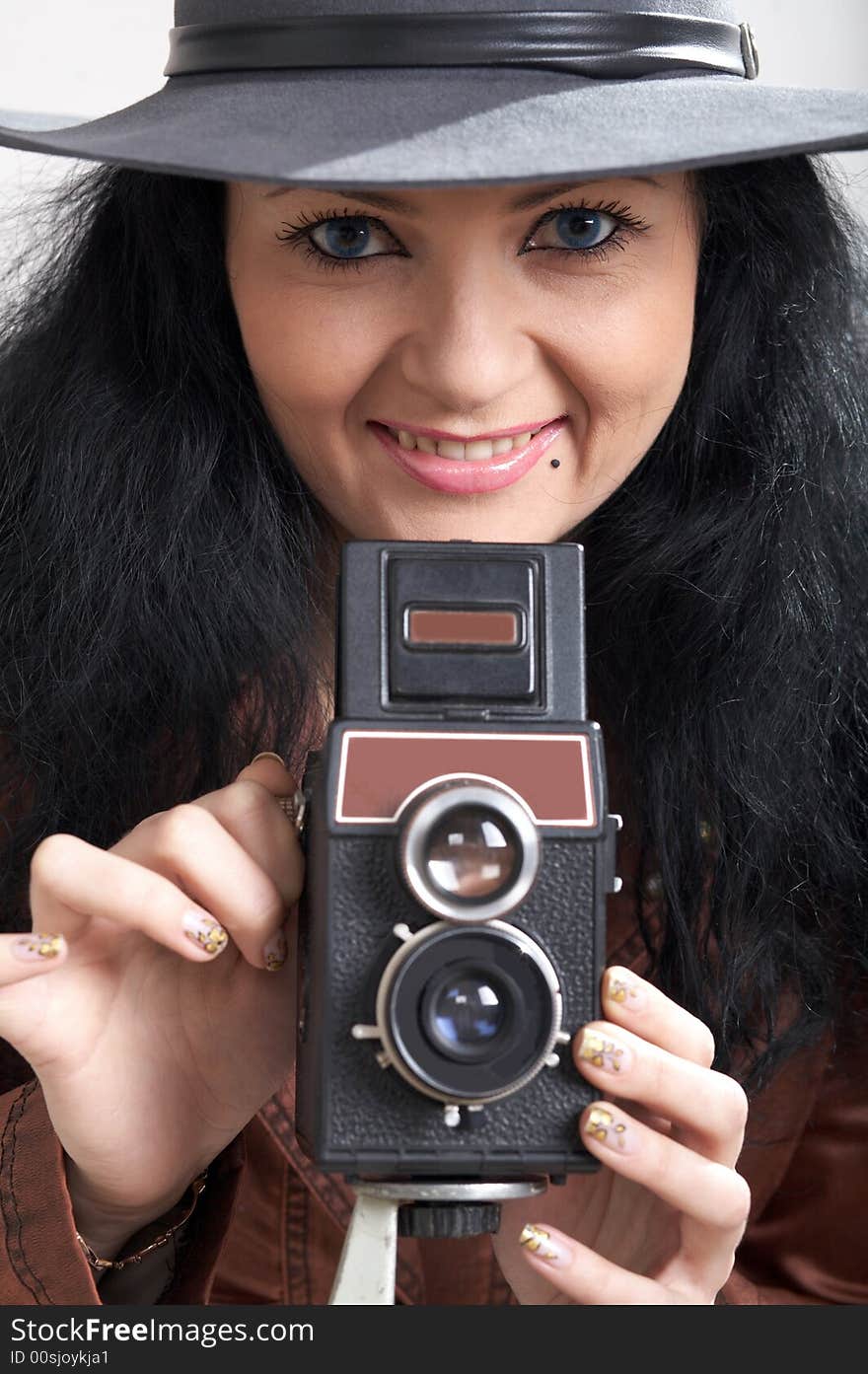 An image of woman with camera in studio. An image of woman with camera in studio