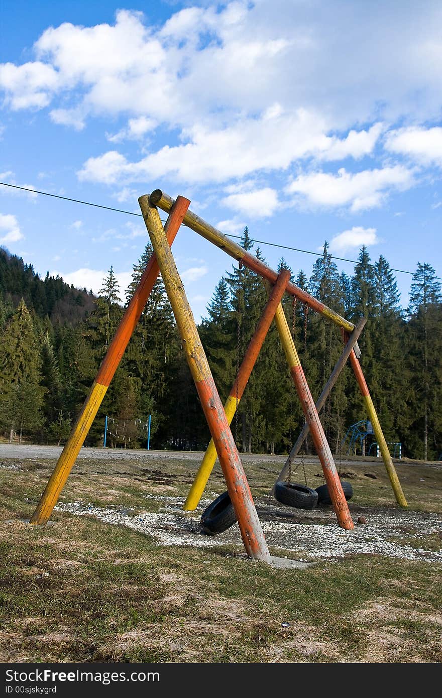 Colourfull empty pair of swings on sunny day at the nature