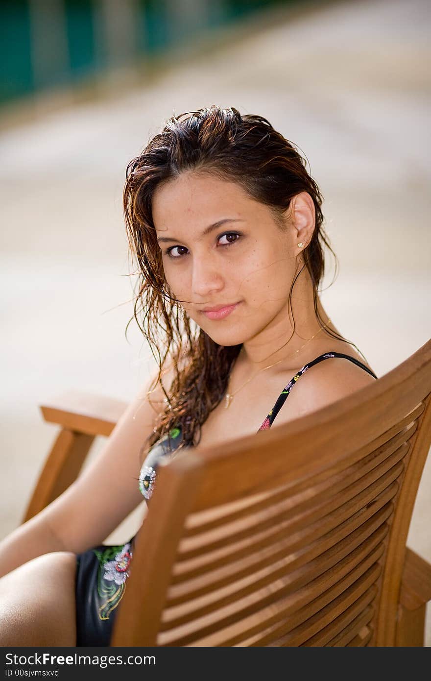 Woman relaxing by the pool