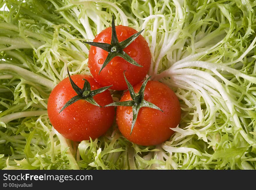 Red ripe tomatoes on green leaf lettuce close-up. Red ripe tomatoes on green leaf lettuce close-up