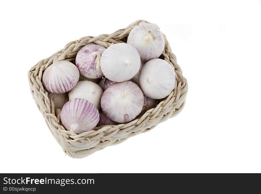 Garlic in a basket isolated on a white background. Garlic in a basket isolated on a white background