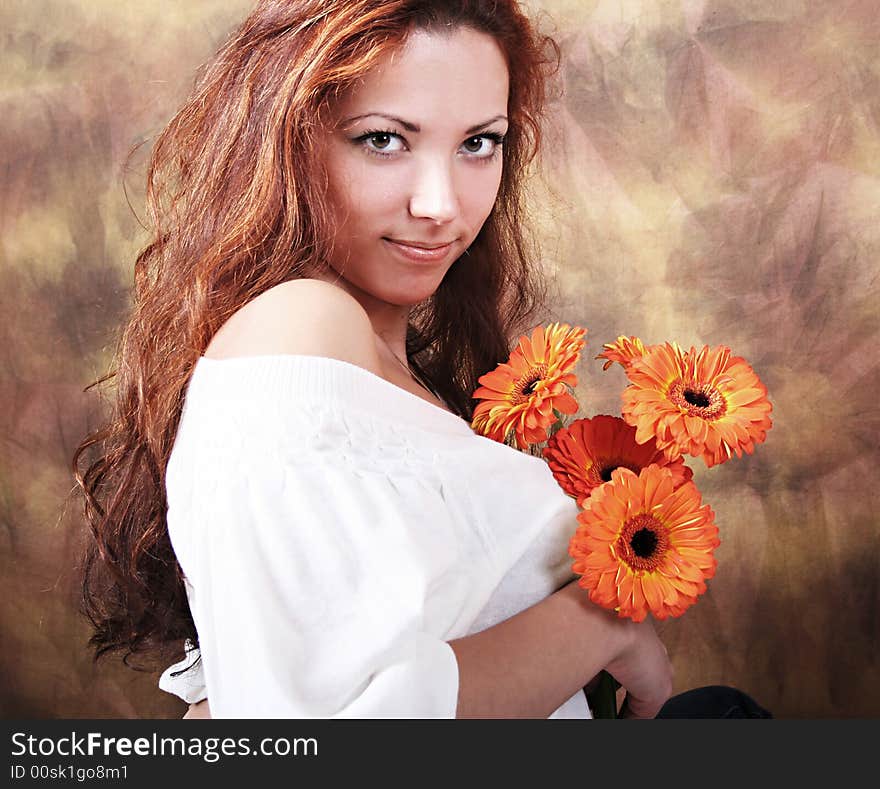 Beautyful young girl with bunch of flowers