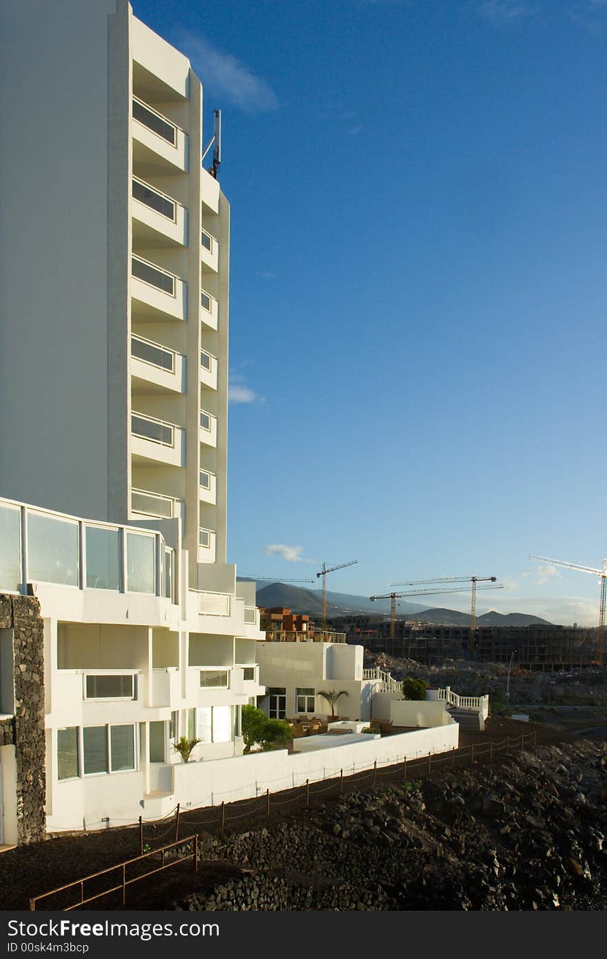 White hotel on the coast surrounded by the construction of new buildings. White hotel on the coast surrounded by the construction of new buildings