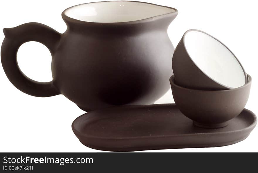 Isolated brown teapot and the cup against a white background. Isolated brown teapot and the cup against a white background