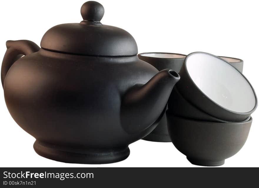 Isolated black teapot and the cups against a white background. Isolated black teapot and the cups against a white background