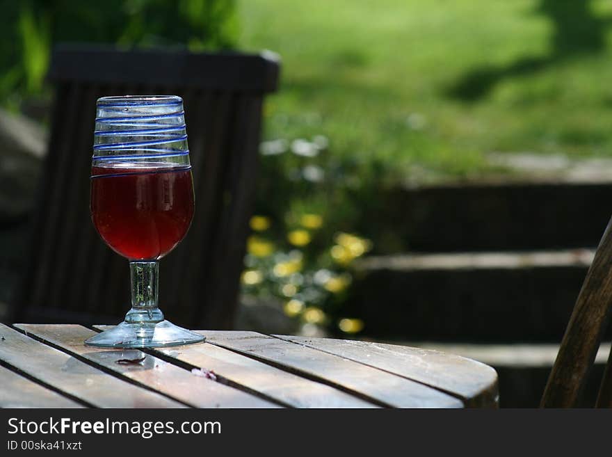 A glass of wine on a summers day in a garden