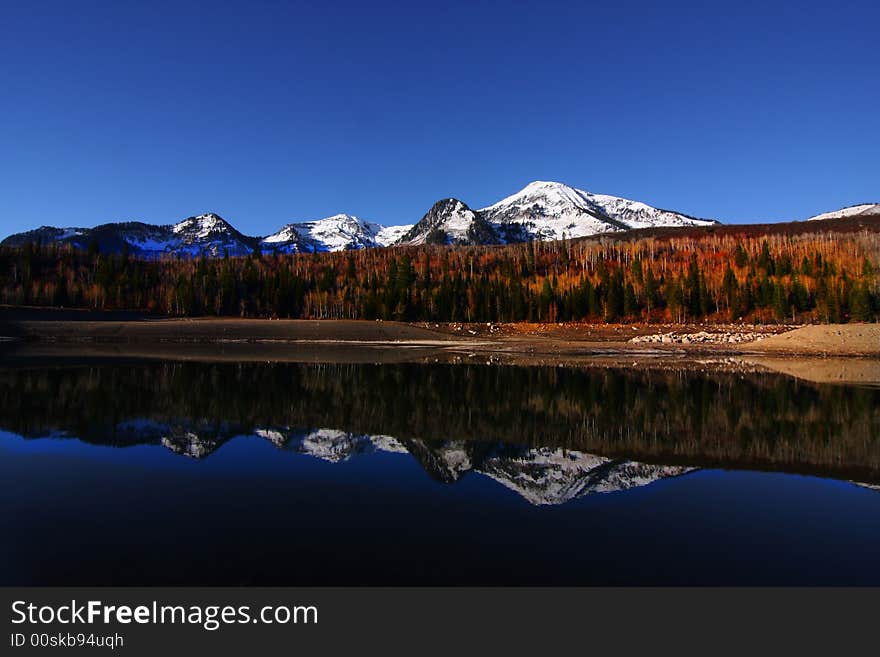 High mountain lake in the fall showing autumn colors reflected in the water. High mountain lake in the fall showing autumn colors reflected in the water