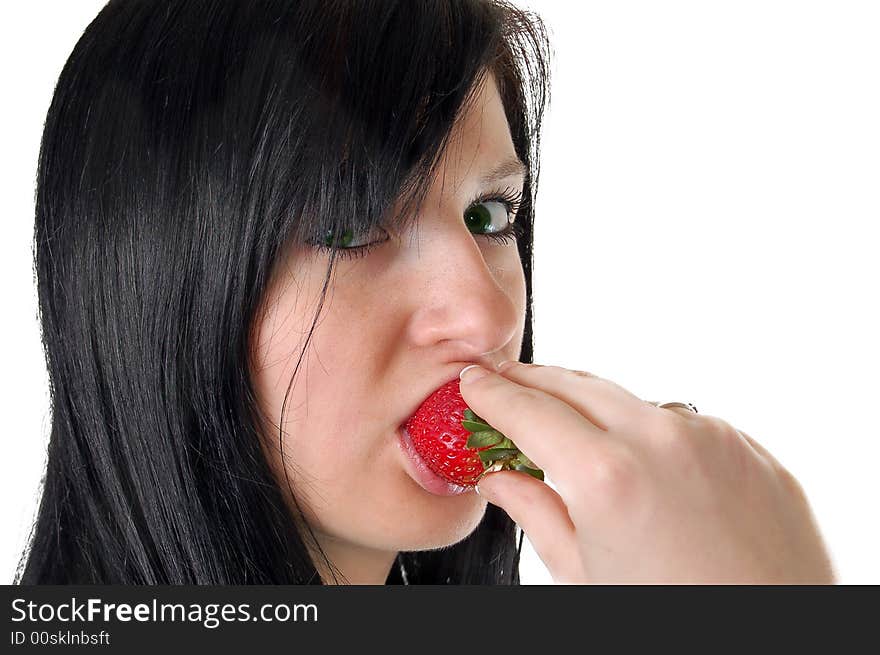 A girl eating a strawberry