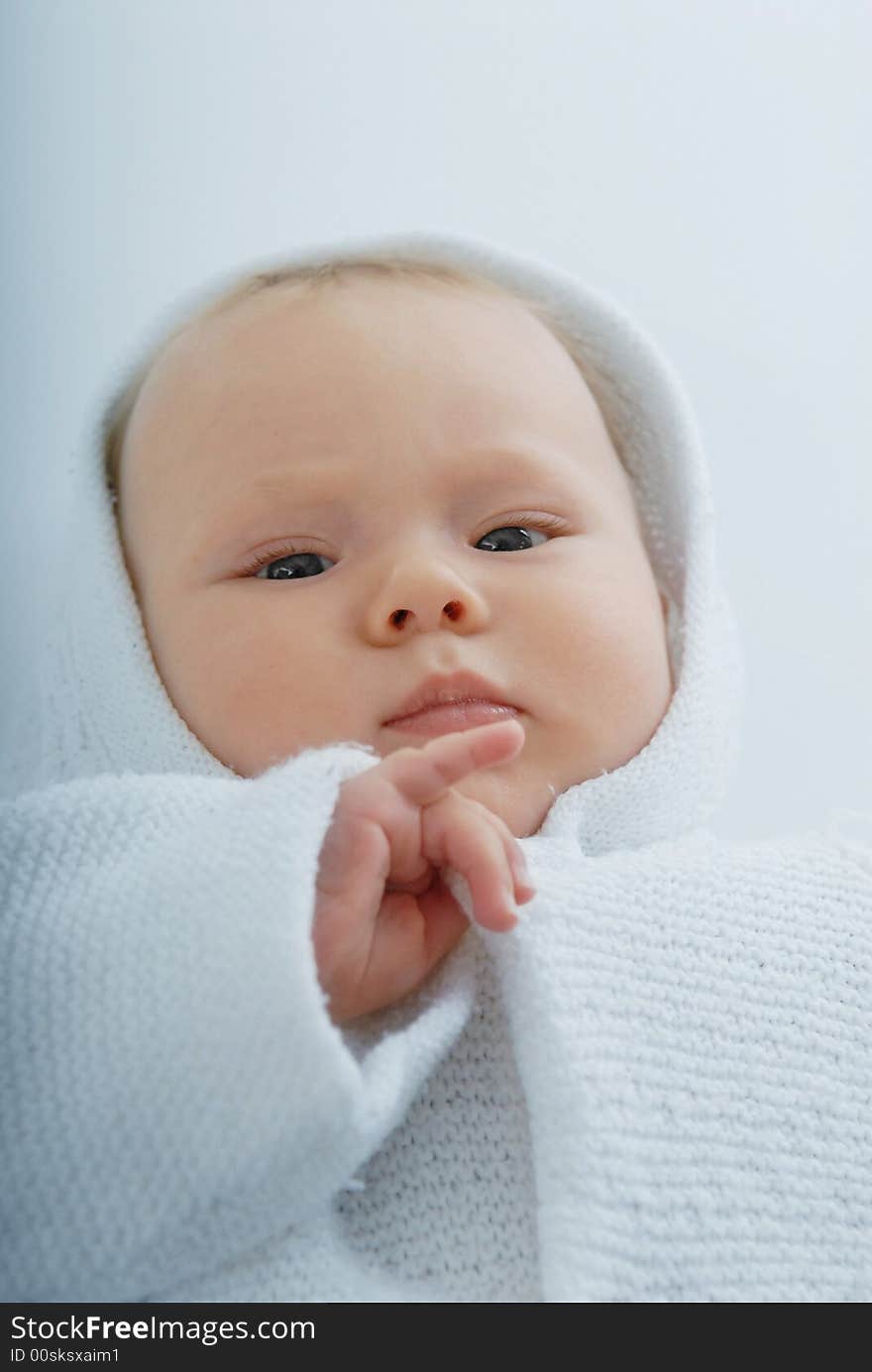 A baby in white hood