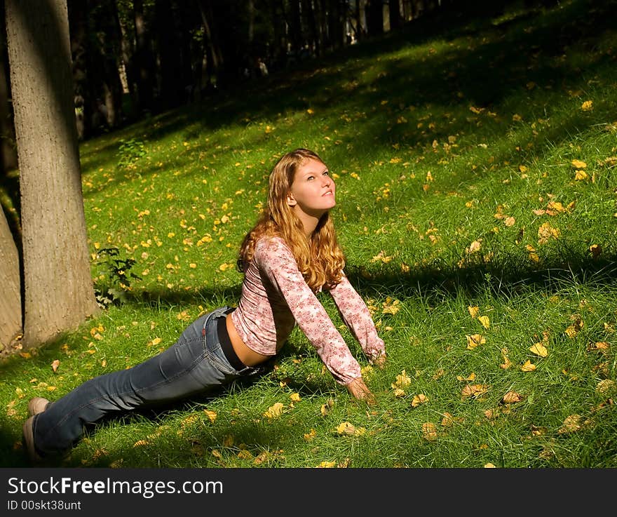 Pretty girl doing exercises on the grass. Pretty girl doing exercises on the grass