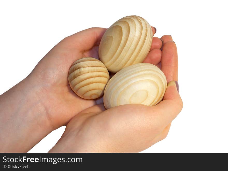 Wooden easter eggs on female palms