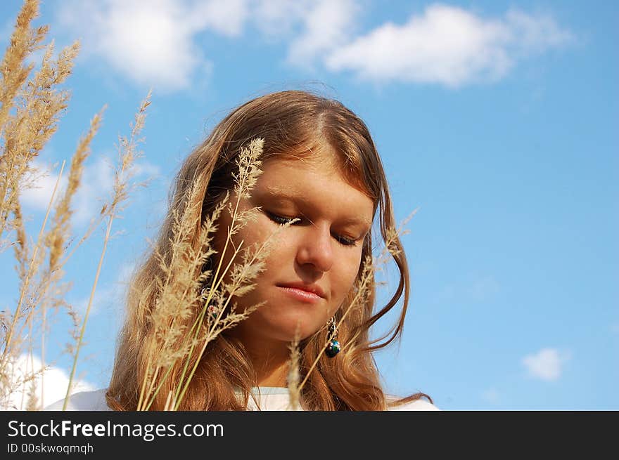 Golden hair girl under the sky