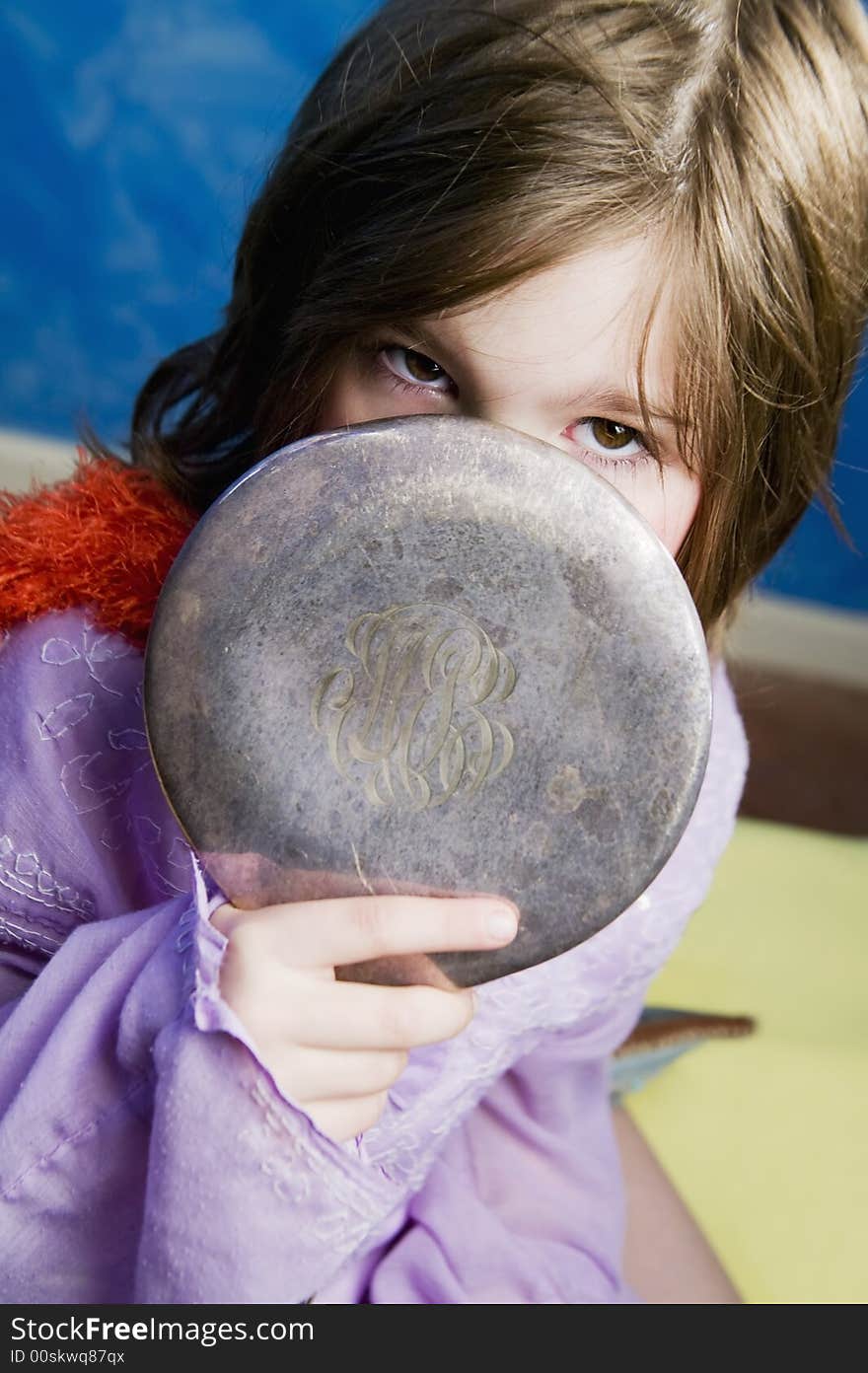 Little Girl Playing Dress-Up with an Antique Handheld Mirror. Little Girl Playing Dress-Up with an Antique Handheld Mirror