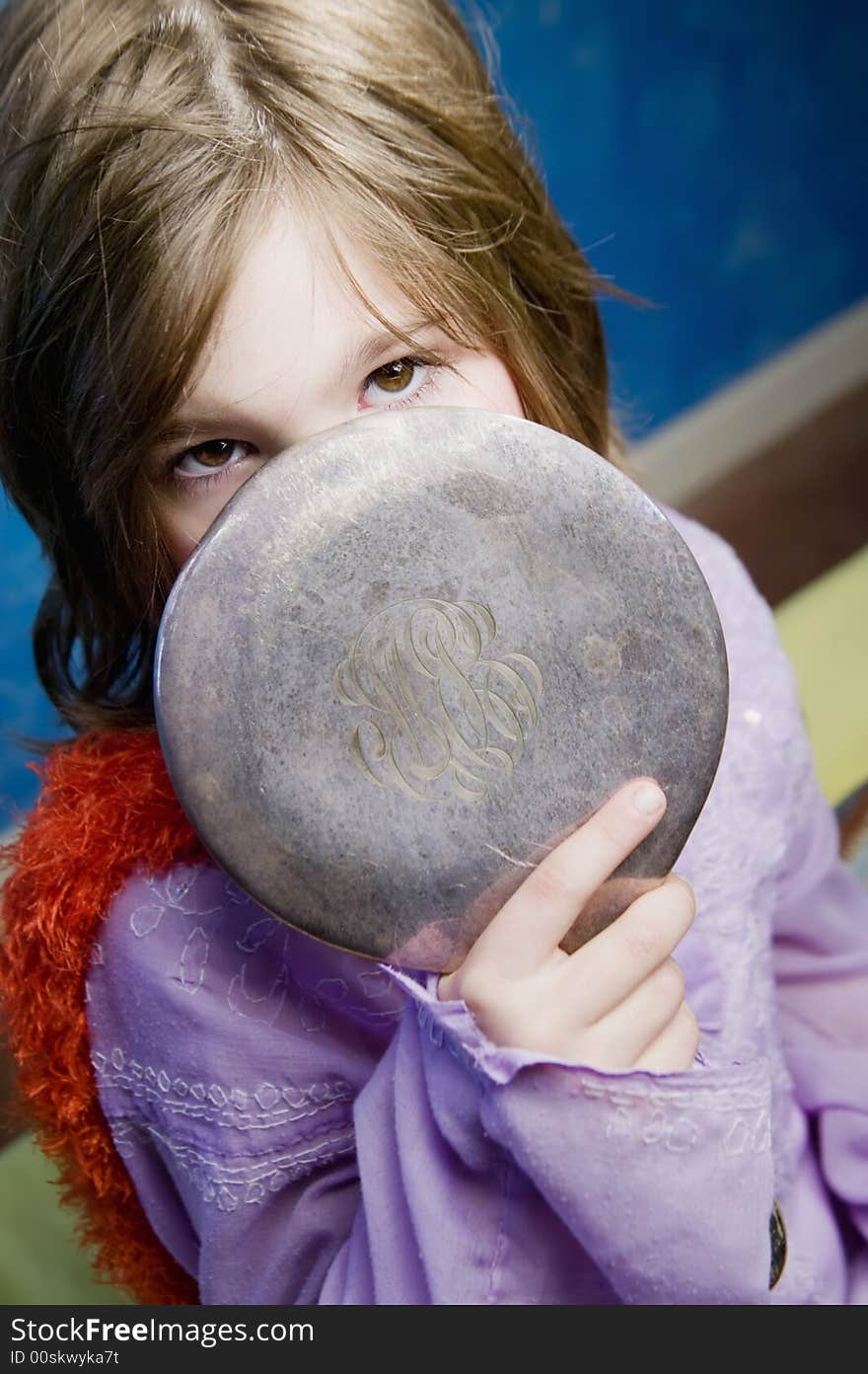 Little Girl Playing Dress-Up with an Antique Handheld Mirror. Little Girl Playing Dress-Up with an Antique Handheld Mirror