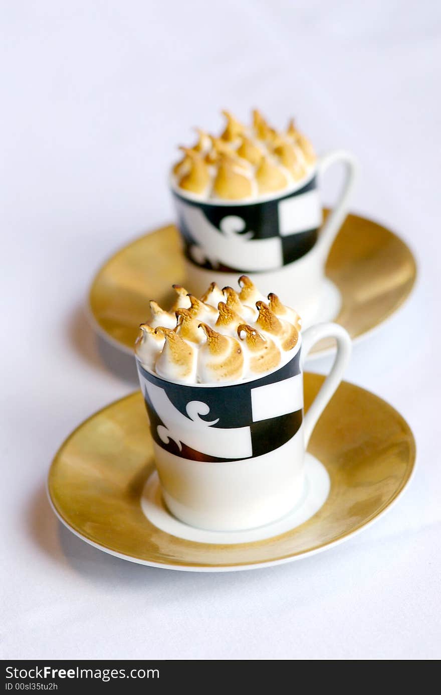 Image of mugs of cappaccino on saucers