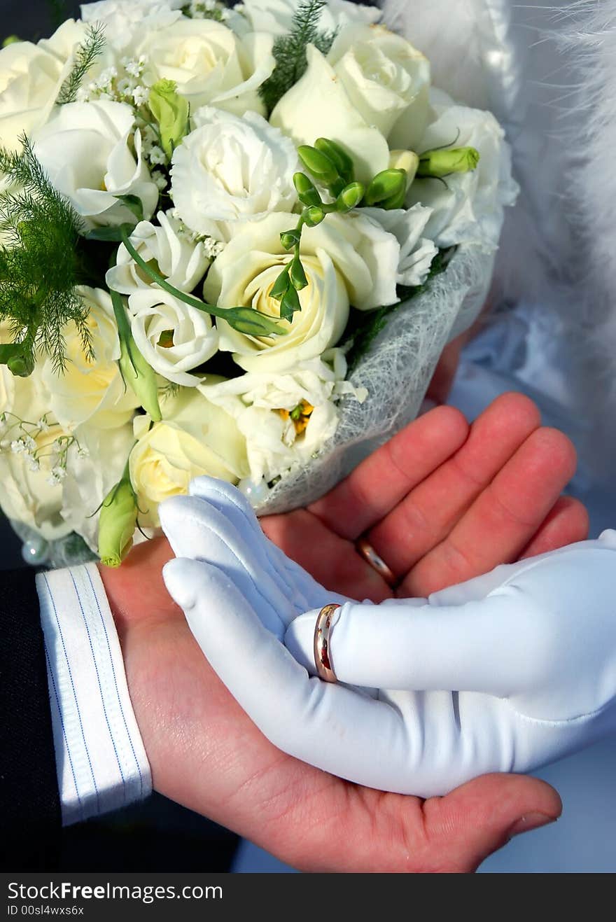 Two hands with rings and flowers