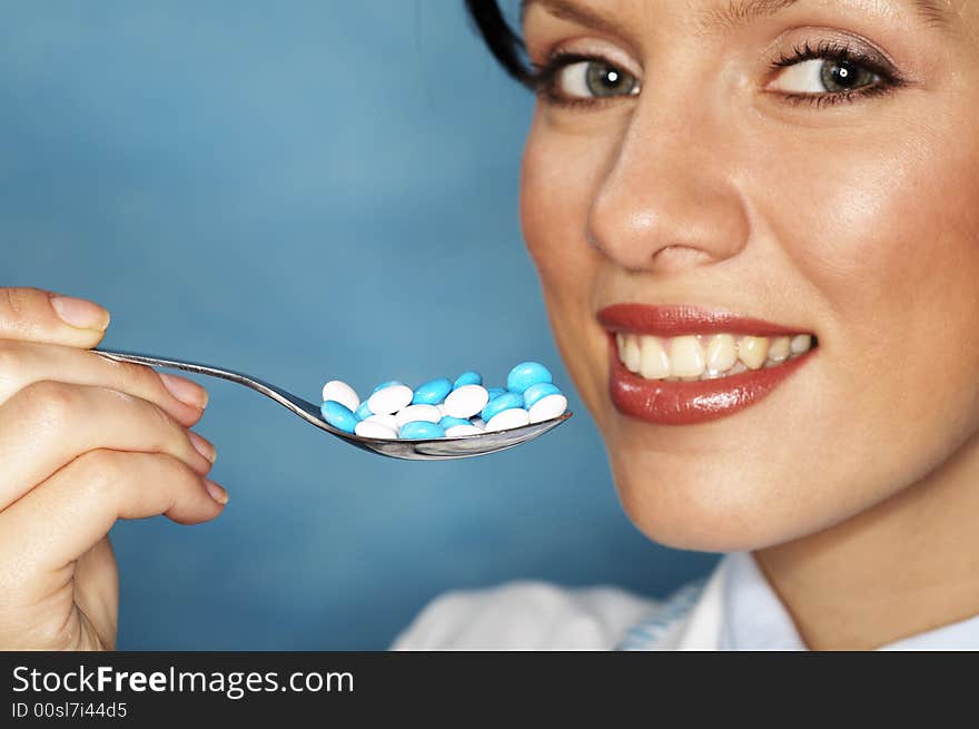 Beautiful caucasian doctor with white/blue pills. Beautiful caucasian doctor with white/blue pills